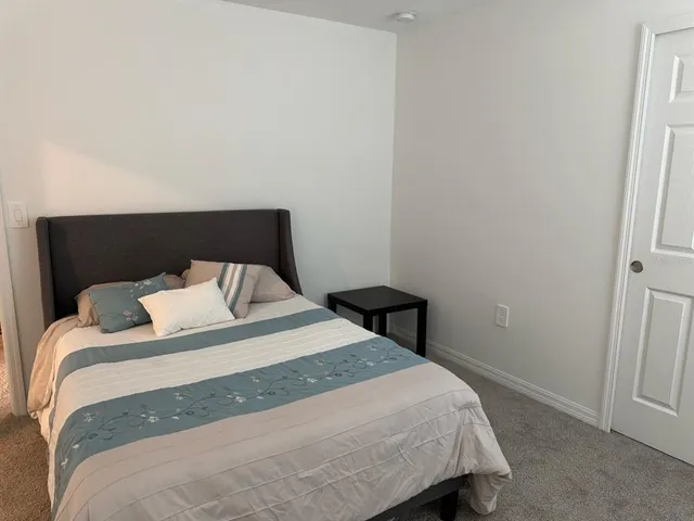 a bedroom with a bed and a window