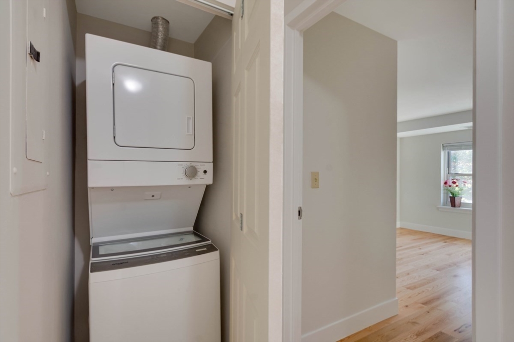 1 Watermill Place, Unit 308 Arlington, MA 02476 - Photo 19 of 27 a utility room with mirror washer and dryer