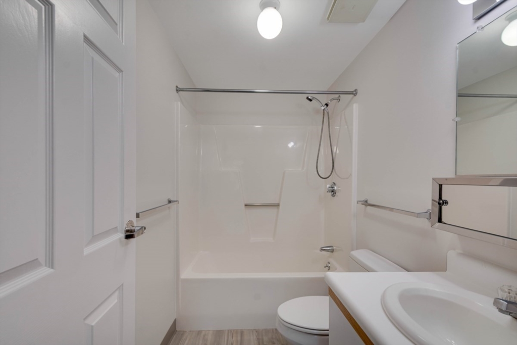 1 Watermill Place, Unit 308 Arlington, MA 02476 - Photo 20 of 27 a bathroom with a toilet sink and shower