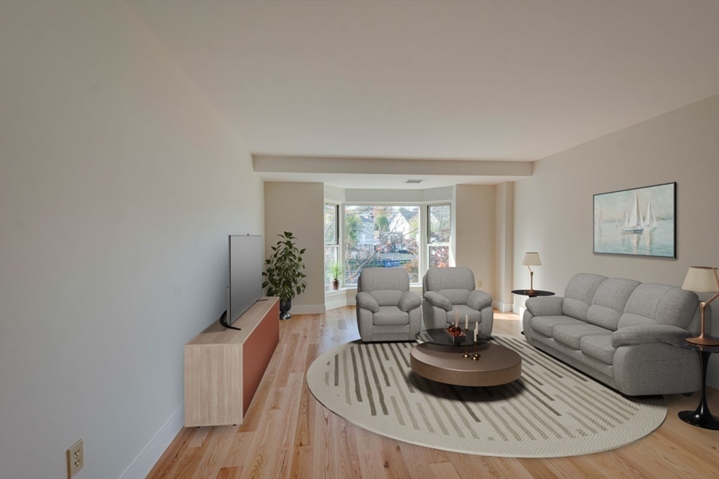 1 Watermill Place, Unit 308 Arlington, MA 02476 - Photo 2 of 27 a living room with furniture and a large window