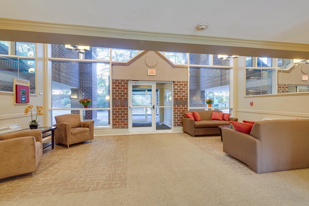 1 Watermill Place, Unit 308 Arlington, MA 02476 - Photo 22 of 27 a living room with furniture and a large window