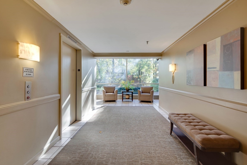 1 Watermill Place, Unit 308 Arlington, MA 02476 - Photo 23 of 27 a living room with furniture and a large window