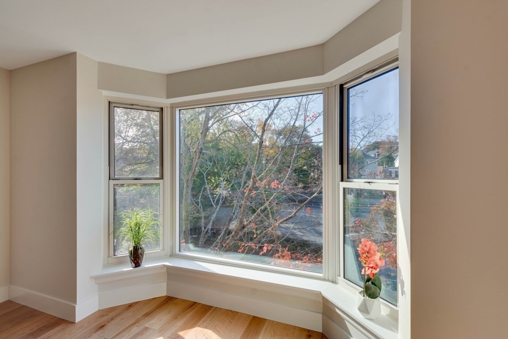 1 Watermill Place, Unit 308 Arlington, MA 02476 - Photo 5 of 27 a view of room with window and wooden floor