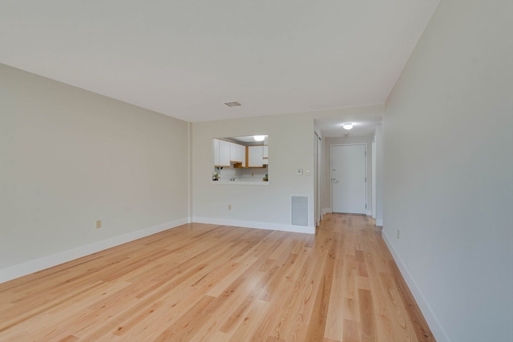 1 Watermill Place, Unit 308 Arlington, MA 02476 - Photo 6 of 27 a view of a big room with wooden floor and windows