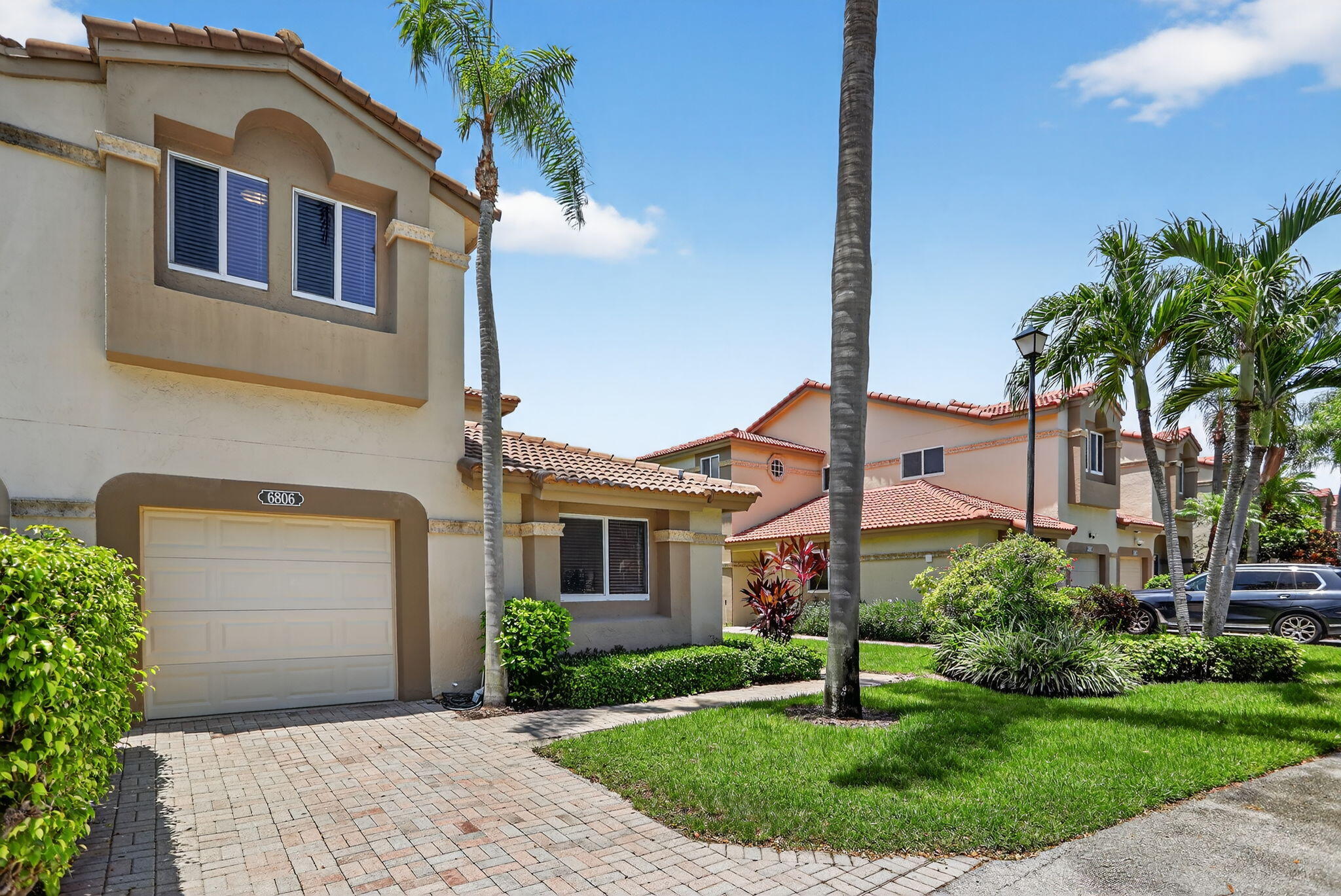6806 Via Regina Boca Raton, FL 33433 - Photo 5 of 51 a front view of a house with a yard and potted plants