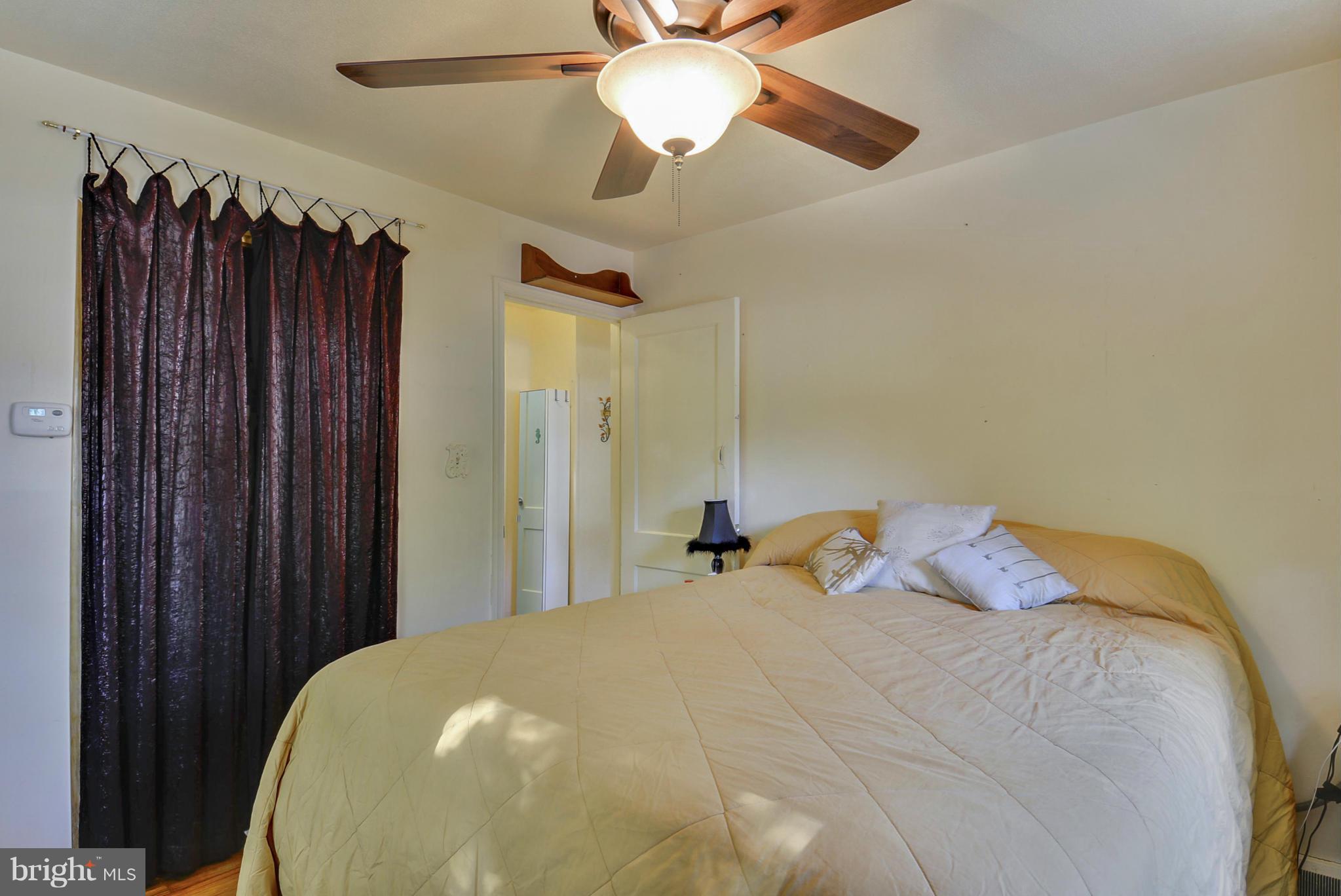 4400 Garrett Park Road Silver Spring, MD 20906 - Photo 12 of 30 a bedroom with a bed and a chandelier