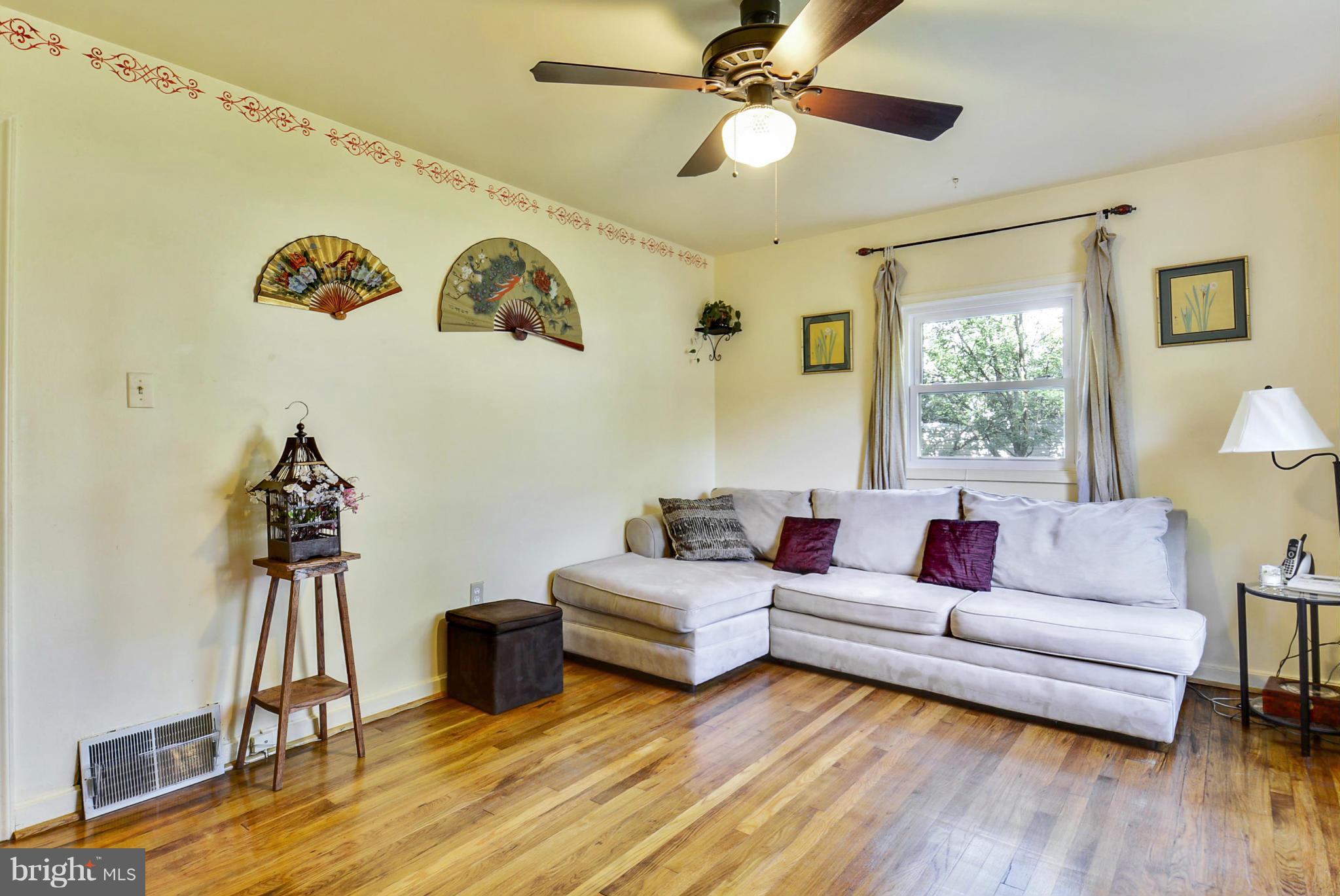 4400 Garrett Park Road Silver Spring, MD 20906 - Photo 5 of 30 a living room with couches painting on the wall and a window