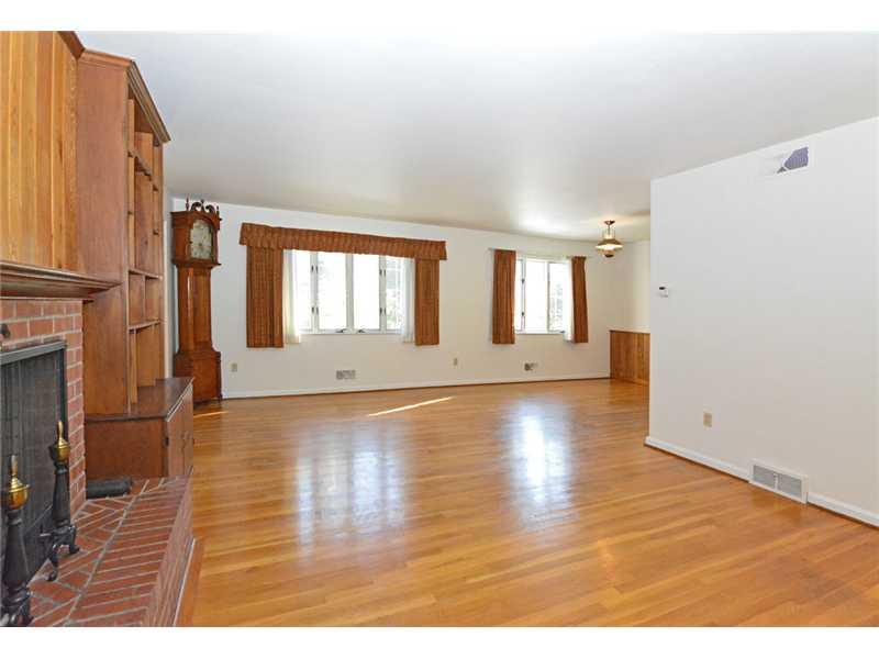 627 West Waldheim Road Fox Chapel, PA 15215 - Photo 7 of 22 Living Room. The spacious living/dining room offers original hardwood flooring, twin built-in bookcases, a handsome raised-hearth brick fireplace and walkout to the covered rear patio.