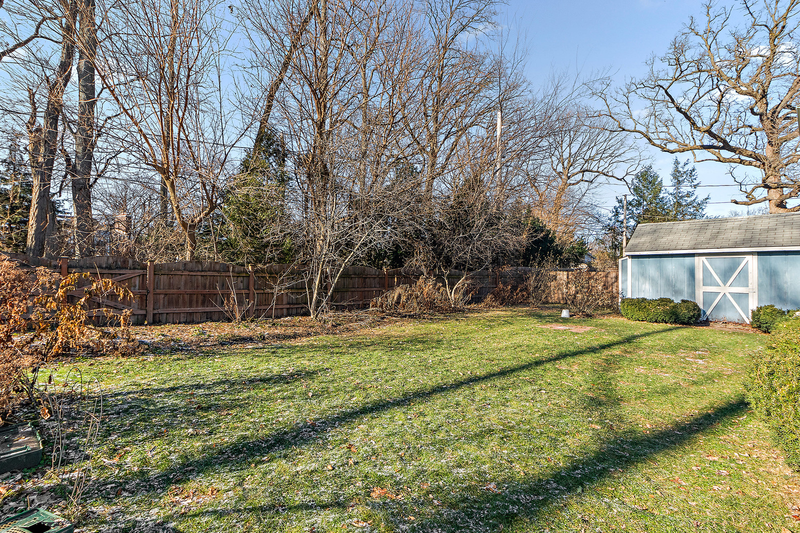 558 Birchwood Road Frankfort, IL 60423 - Photo 16 of 16 a backyard of a house with large trees and barbeque oven