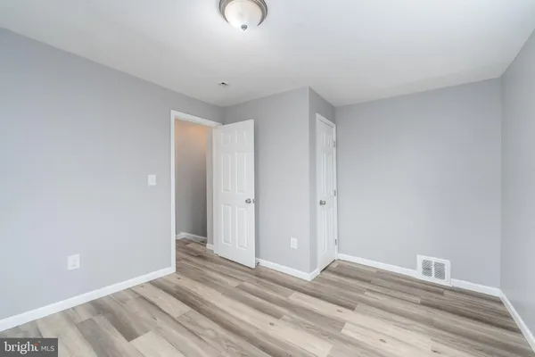 a view of a room with wooden floor and bathroom