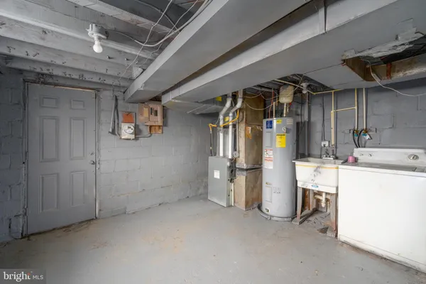 a view of storage and utility room with refrigerator and washer
