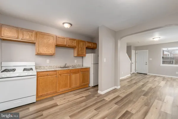 a kitchen with stainless steel appliances granite countertop a sink and cabinets