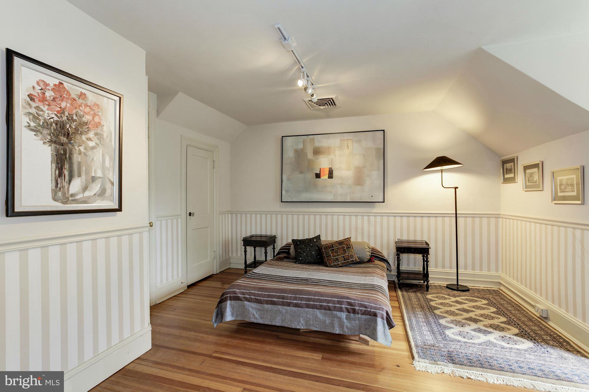 1743 Webster Street Northwest Washington, DC 20011 - Photo 18 of 24 a bedroom with a bed and a painting on the wall