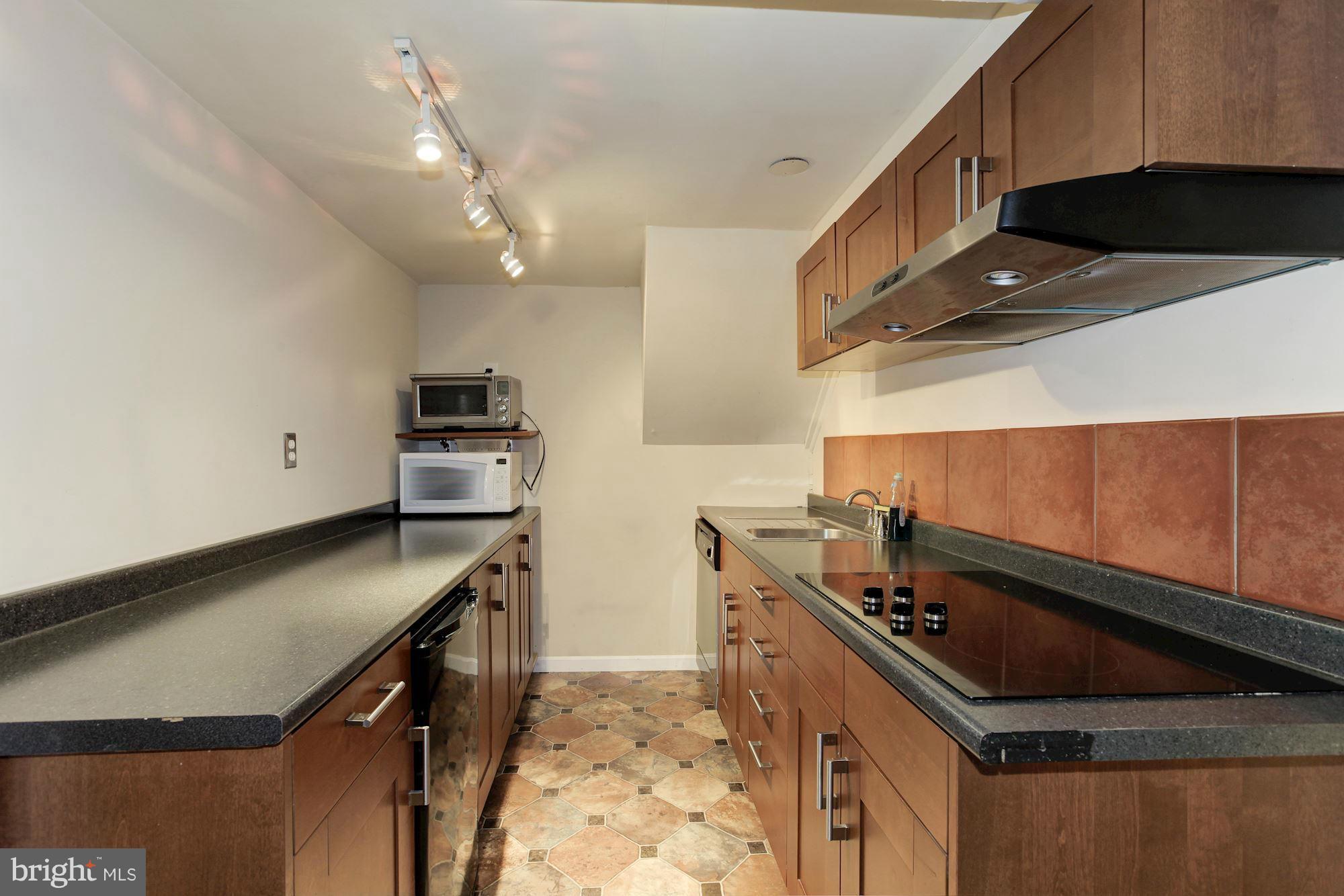 1743 Webster Street Northwest Washington, DC 20011 - Photo 21 of 24 a kitchen with stainless steel appliances granite countertop a stove a sink and a microwave