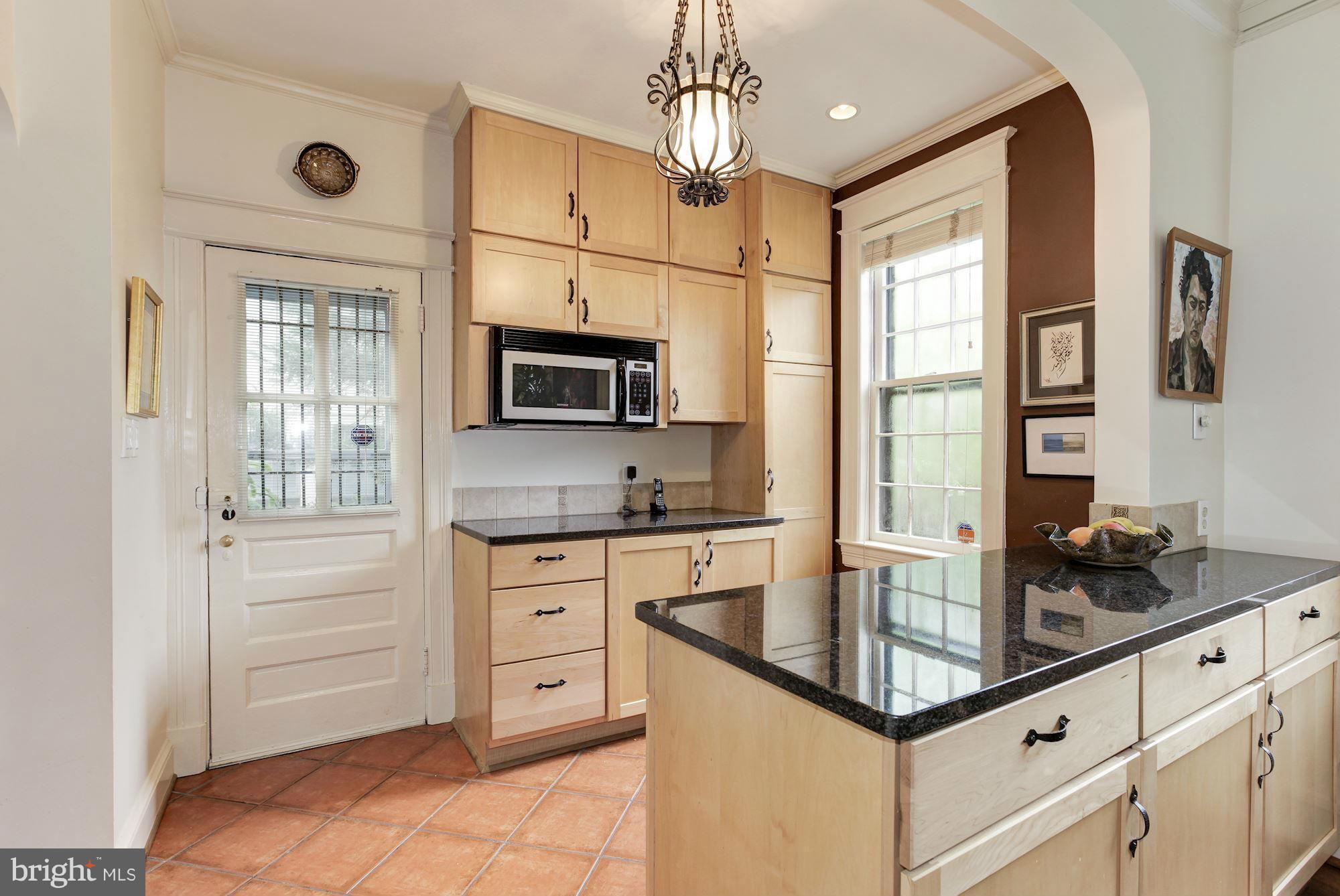 1743 Webster Street Northwest Washington, DC 20011 - Photo 10 of 24 a kitchen with stainless steel appliances granite countertop a sink refrigerator stove and microwave