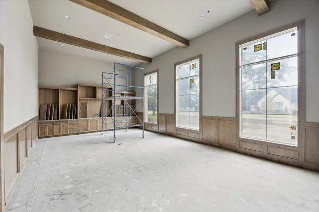 an empty room with window and mirror