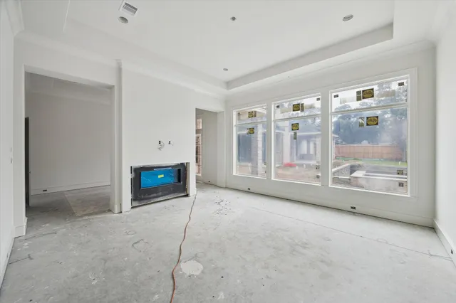 a view of a porch with a table and chairs and iron fence