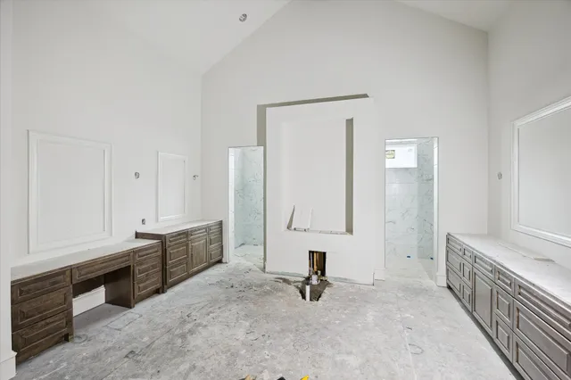 a view of swimming pool that has lawn chairs with plants