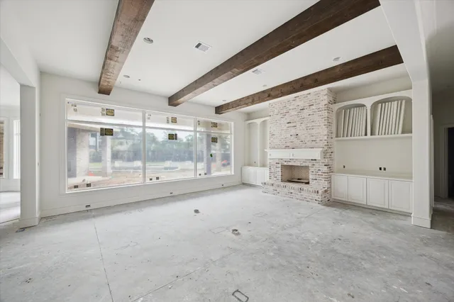 a view of an empty room with a fireplace