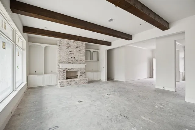 a view of empty room with a fireplace