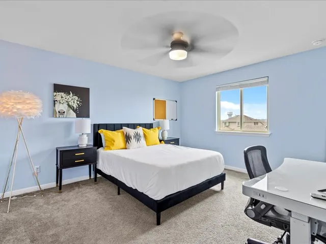 a bedroom with a bed and a chair