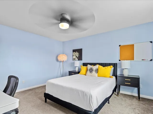 a bathroom with a double vanity sink toilet mirror and shower