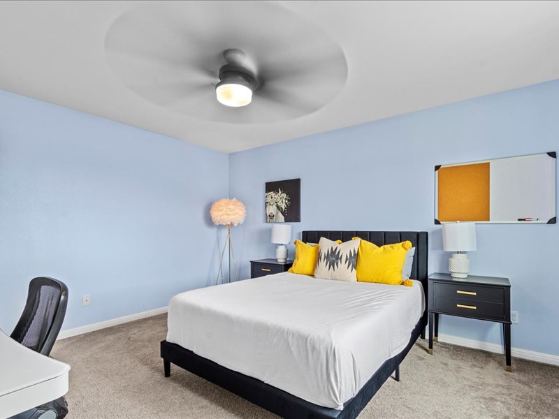 8201 Daisy Cutter Crossing Georgetown, TX 78626 - Photo 16 of 31 Bedroom featuring light carpet, a ceiling fan, and an office area