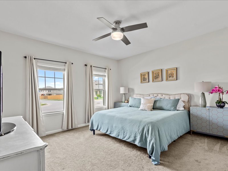 8201 Daisy Cutter Crossing Georgetown, TX 78626 - Photo 18 of 31 Bedroom featuring light carpet and ceiling fan