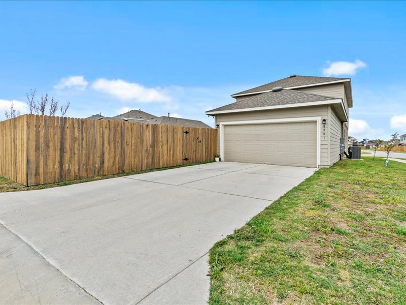 8201 Daisy Cutter Crossing Georgetown, TX 78626 - Photo 20 of 31 View of property exterior with roof with shingles, concrete driveway, and a garage