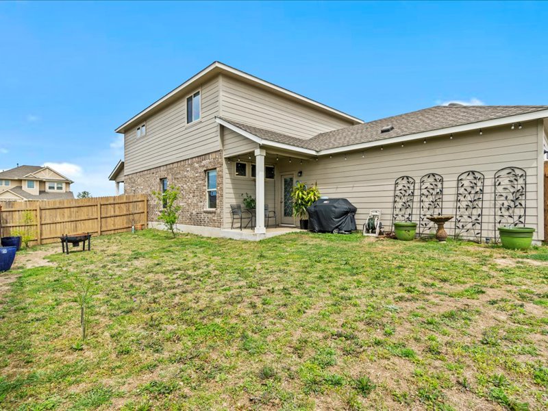 8201 Daisy Cutter Crossing Georgetown, TX 78626 - Photo 22 of 31 Back of house with a patio area, a fenced backyard, brick siding, and a shingled roof