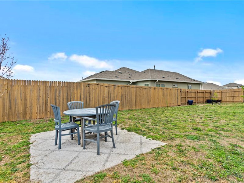 8201 Daisy Cutter Crossing Georgetown, TX 78626 - Photo 23 of 31 Fenced backyard with a patio and outdoor dining space