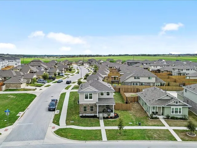 an aerial view of residential houses with outdoor space