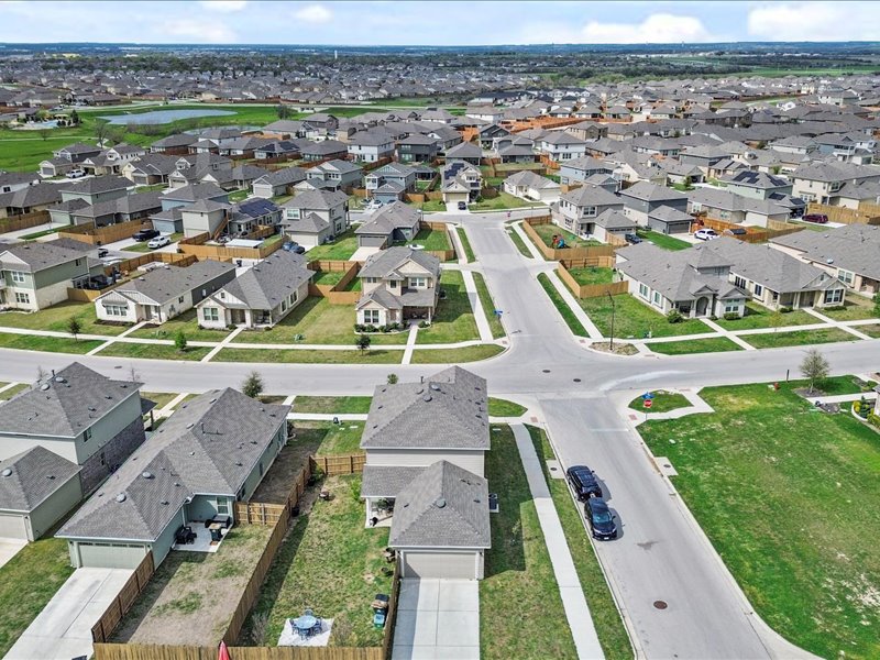 8201 Daisy Cutter Crossing Georgetown, TX 78626 - Photo 29 of 31 Aerial perspective of suburban area featuring a large body of water