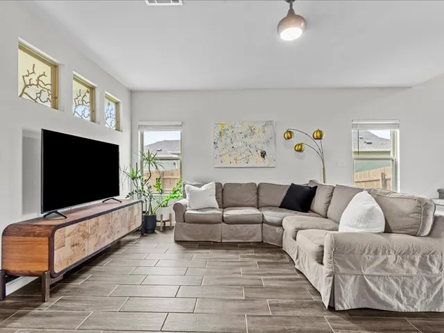 a living room with furniture and a flat screen tv