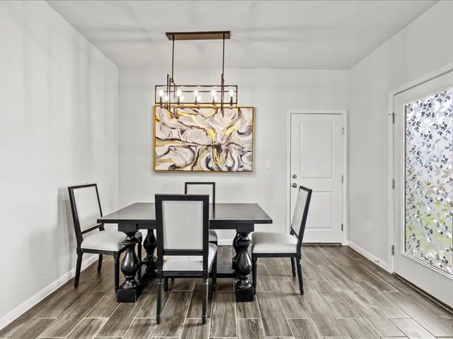 a view of dining room and livingroom with furniture wooden floor windows and a chandelier