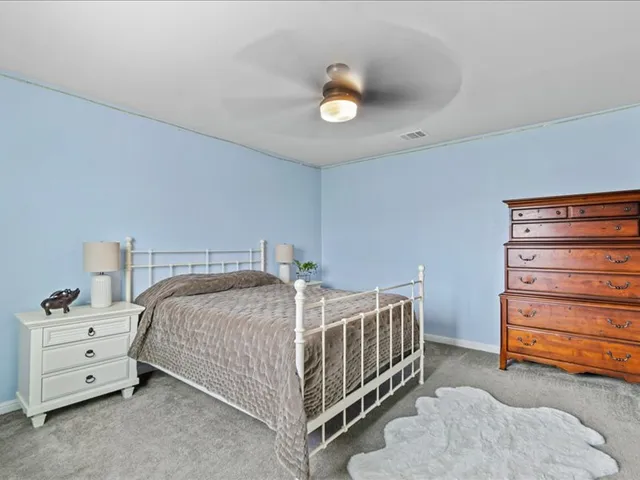 a living room with furniture a window and a piano