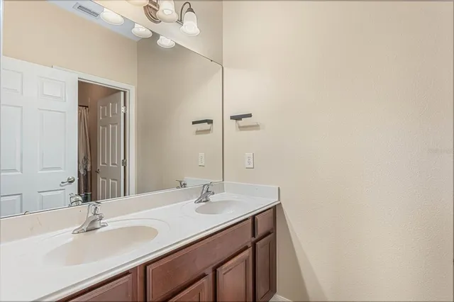an empty room with a ceiling fan and a window