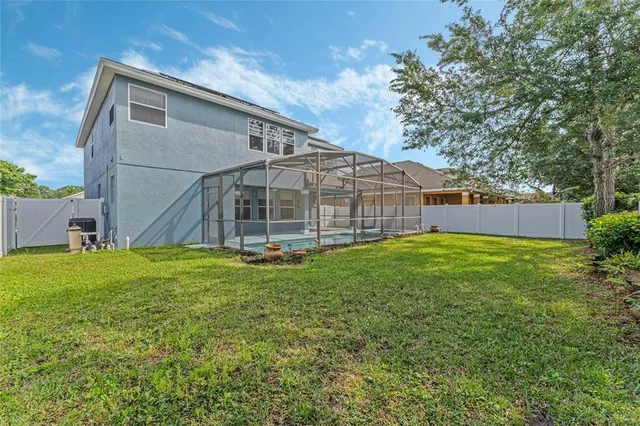 an aerial view of a house with a yard