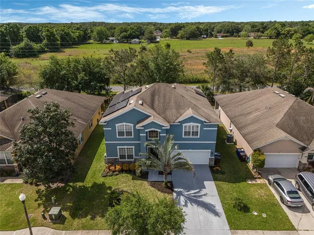 an aerial view of residential houses with outdoor space