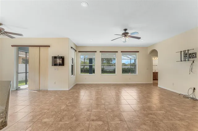 a view of an empty room with a kitchen