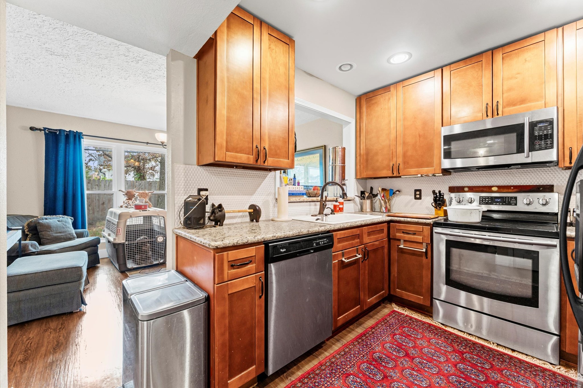 1504 Early Lane Houston, TX 77055 - Photo 2 of 23 a kitchen with stainless steel appliances granite countertop a stove a sink and a microwave