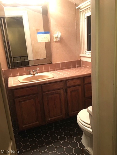 9124 Snow Road Cleveland, OH 44130 - Photo 20 of 23 Bathroom with toilet, tasteful backsplash, tile floors, and sink