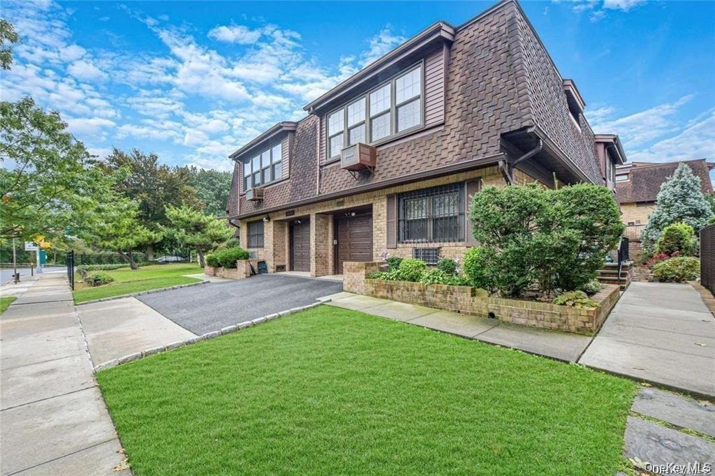 a view of a house with a yard and plants