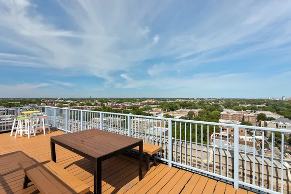 a view of a balcony with wooden floor and city view