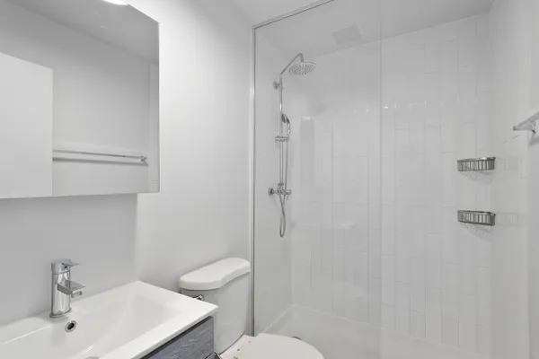 a bathroom with a sink toilet and shower