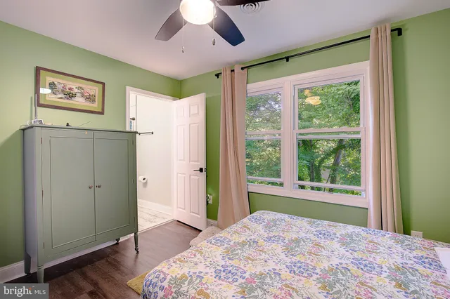 a bedroom with a large bed and a large window