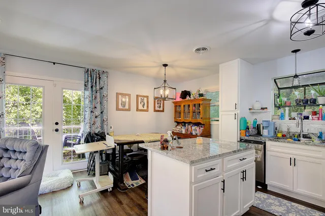 a kitchen with granite countertop a sink stove and cabinets
