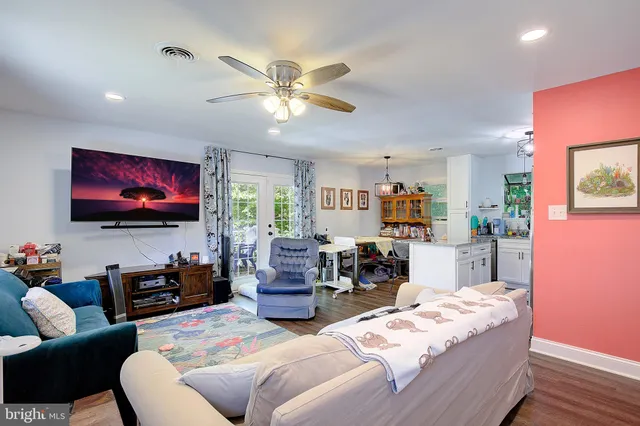 a living room with furniture a large window and a flat screen tv