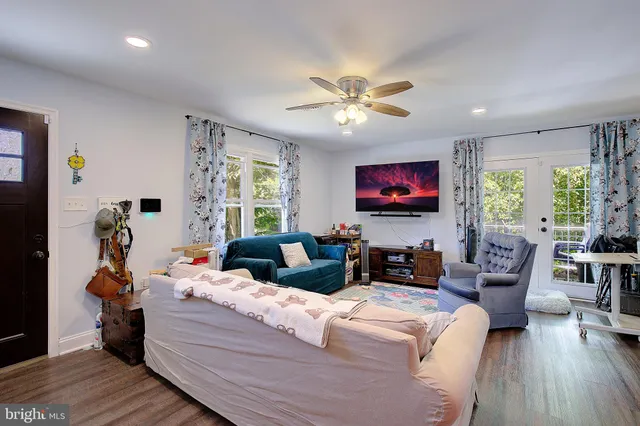 a living room with furniture and a flat screen tv