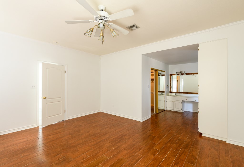 4488 Blue Ridge Drive Belton, TX 76513 - Photo 17 of 35 a view of empty room with wooden floor and fan